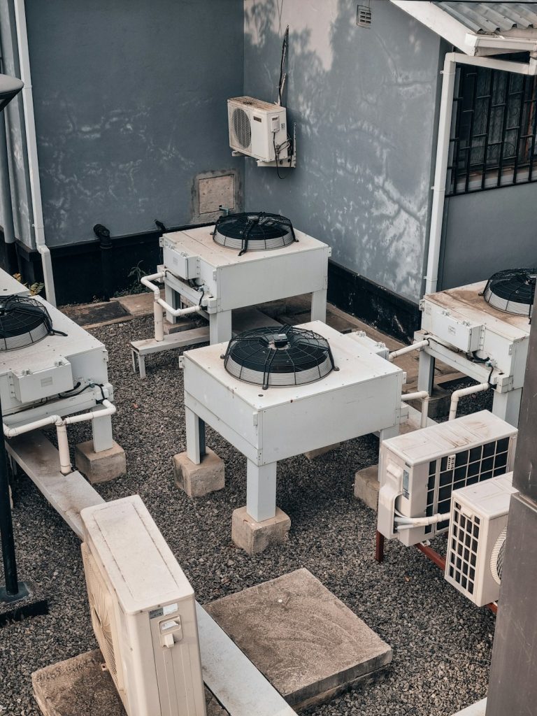 air-conditioning-units-are-shown-outdoors-on-concrete-w9o8oz-q054
